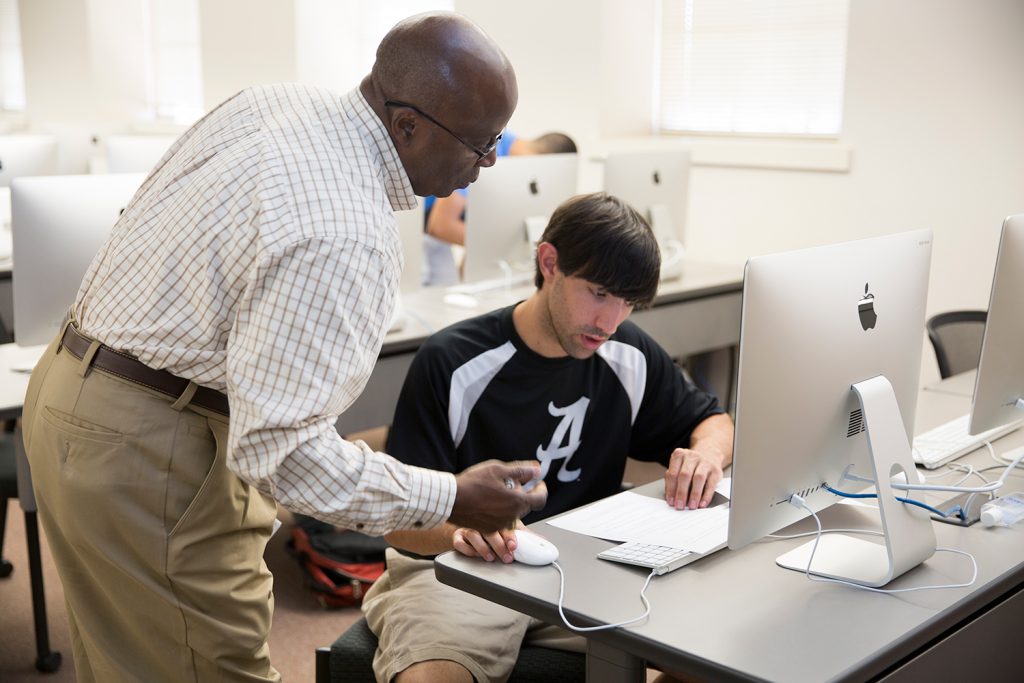 Dr. Williams helping a student with an assignment