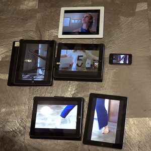 iPads arranged on the floor to show different images of a dancer