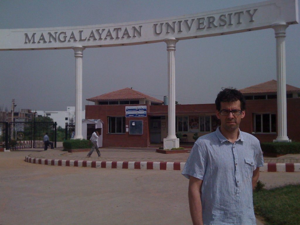 Nathan Loewen standing in front of Mangalayatan University, Aligarh, U.P.