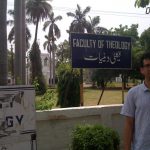 Nathan Loewen standing in front of Aligarh Muslim University