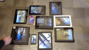 iPads arranged on the floor to show images of a dancer at different angles
