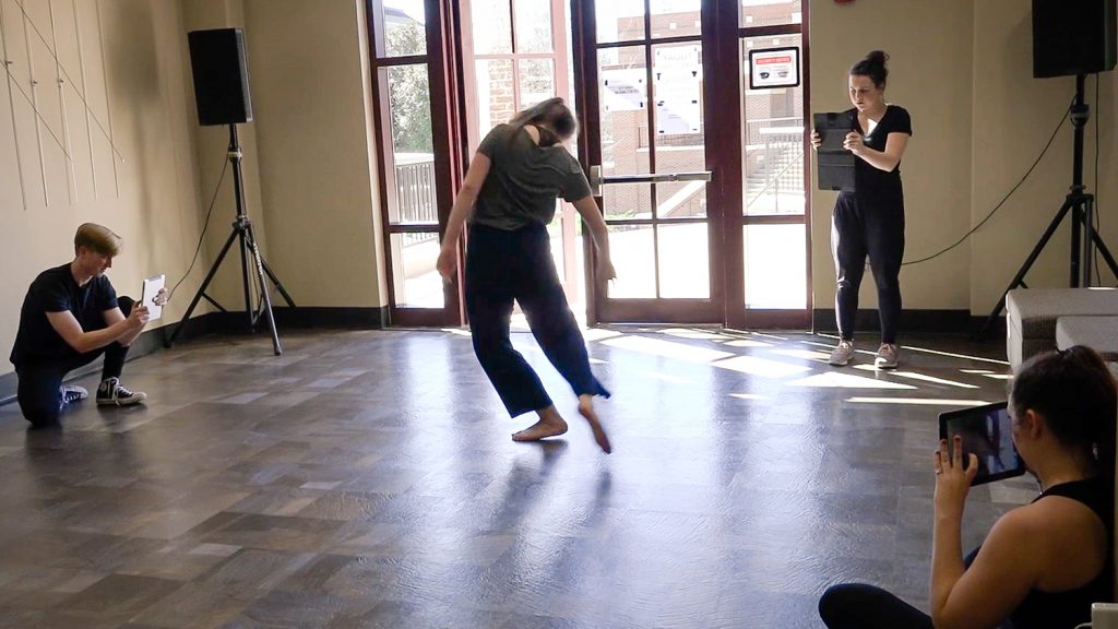 3 students filming a dancer with iPads