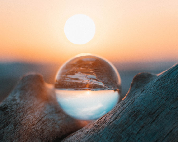 reflection of sunset in glass photography ball