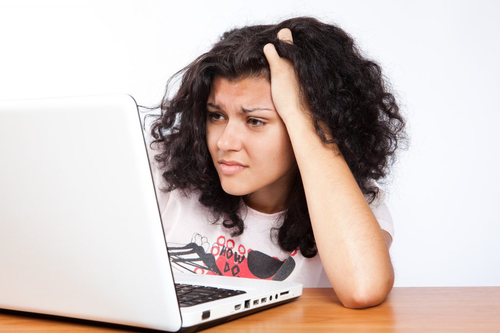 confused woman looking at computer