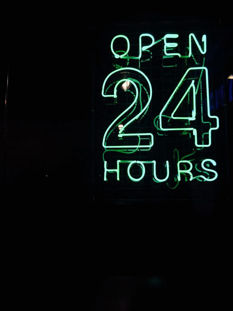 neon sign saying open 24 hours