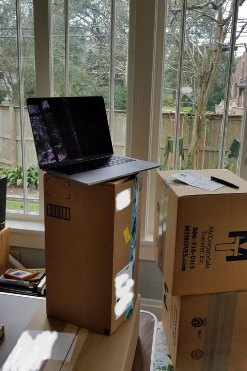 laptop set on moving boxes
