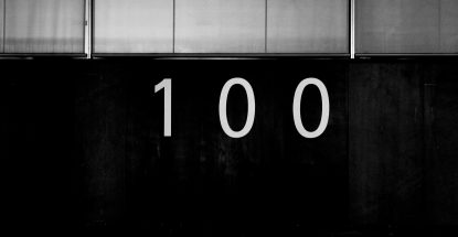 Black and white image of "100."